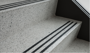 gray terrazzo stair treads and risers with three black abrasive strips
