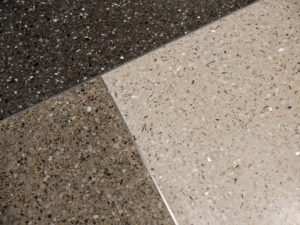 brown, beige, and black terrazzo floor with metal divider strips