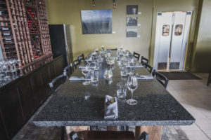 black terrazzo table top with wine glasses and napkins