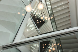 white terrazzo staircase with white walls and lights