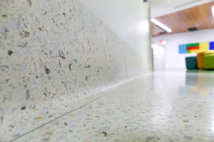 white terrazzo cove base with white terrazzo floor and toe strip