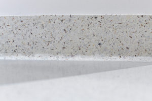 white terrazzo cove base with a gray and white microblend terrazzo floor and white walls